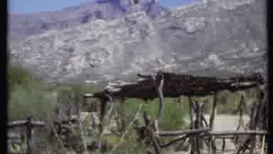 California USA (1971): A Stick Hut Sitting Under A Rocky Mountain With A Grassy