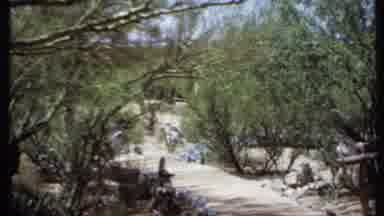 California USA (1971): A Small Bridge Leads To A Square Dirt Dwelling In An Arid