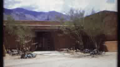 California USA (1971): People Enter An Adobe-Like Building In A Western Town