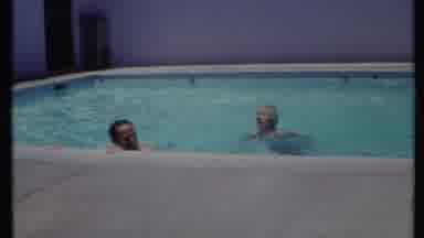 California USA (1971): Two People Are Swimming In The Swimming Pool Outdoors And