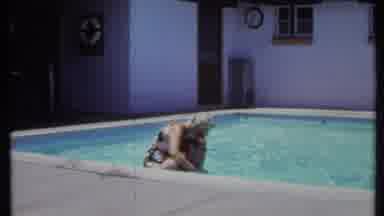 California USA (1971): Person Sitting On Someone's Shoulders As He Swims Around