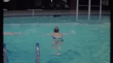 California USA (1971): A Few People Swimming In The Clear Water Of A Small Public