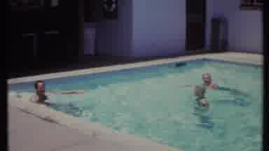 California USA (1971): Vintage Home Family Swimming In Backyard Pool During Summer