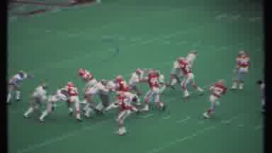 Ithaca New York (1979): Football Players Running A Play On A Green Field Close To