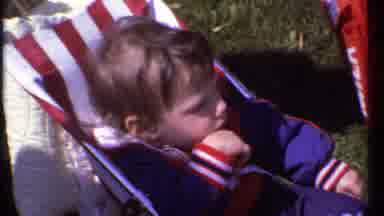 Ithaca New York (1979): Child In Stroller Watches Cars Roll By Then Is Pulled Away