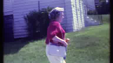 Vermont USA-1984: Woman in Red Sweater Walking Outside with Purse