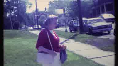 Vermont USA-1984: Lady Outside Looks At Camera And Slowly Moves To The Right
