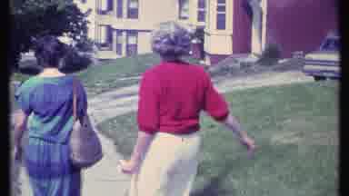 Vermont USA (1984): Two Ladies Walk Down A Walkway Then Woman On Left Shrugs Her