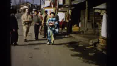 Japan (1952): Individual In Dress And Other Individual In Pants Walking Doesn't He