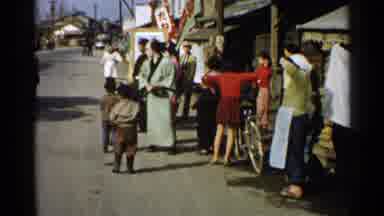Japan (1952): Asian People Wearing Festive Clothing Walking And Banging On