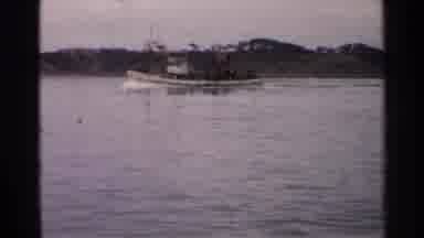 Japan (1952): An Old And Rusty Ship Making Its Way Through A Body Of Water