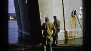Japan (1952): Two Crew Members Walk Past Boat While Puffing On Their Pipes