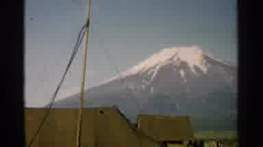 Japan (1952): Mountain In The Distance With Snow At The Top And Tents At The
