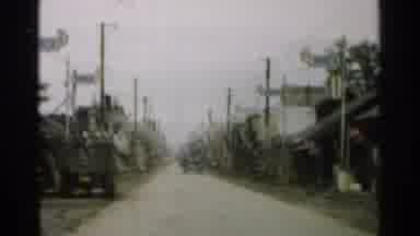 Japan (1952): Military Vehicle Driving Through And Old Small Town Showing Old