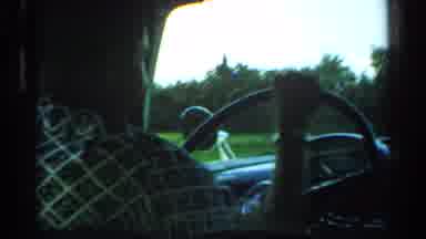 Japan (1952): Moving Car With Driver Passes Open Field Then Sitting Airplane Is