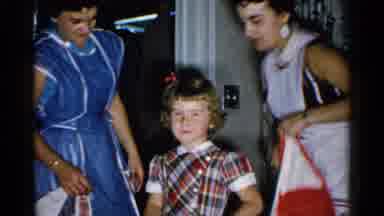 New Hampshire (1952): Young Girl Posing While Apron Is Taken Off By Woman