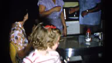 New Hampshire (1952): Multi-Generational Gathering In A Yellow Kitchen Where A Man