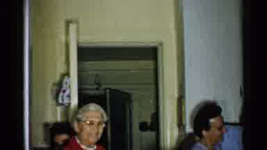 New Hampshire (1952): At A Gathering A Man In Glasses Hugs And Kisses A Woman In A