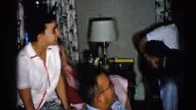 New Hampshire (1952): Man Wearing Blue Pants Plays Guitar For People Sitting On
