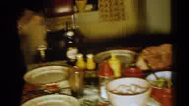 New Hampshire (1952): Family Members Circle Around A Table Full Of Dishes And Food