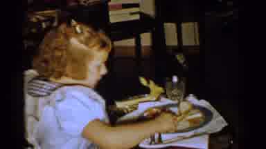 New Hampshire (1952): High Angle A Little Girl Sitting At A Table While Eating A