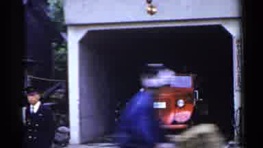 Japan (1953): Child Rides By Open Garage Door Then Comes The Other Way Passed Man