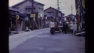 Japan (1953): A Family And A Cart Moving Down A Road Through A Poor Area