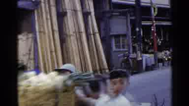 Japan (1953): Asian Town With Bamboo Walls Small Houses And Children Helping