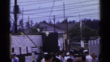 Japan (1953): A Crowd Of People And Carnival Workers On A Sunny Day At A Street