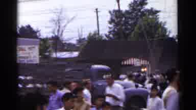 Japan (1953): Crowd Walking Trucks Driving At Bazaar People Parachuting Down