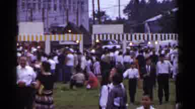 Japan (1953): Large Group Of People Standing Next To Large Gray Tent On A Cloudy