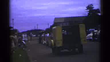 Japan (1953): Small Town With People Gathered Around Leaving Their Trash And Cars