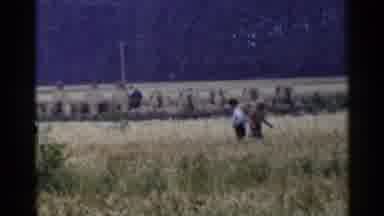 Japan (1953): Man In Hat Walking Past Man In Blue Shirt In Field
