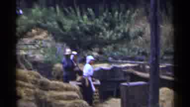 Japan (1953): People Working Near A Wooden Building With Hay Surrounding Them