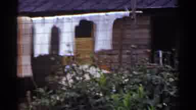 Japan (1953): Laundry Line With Woman Beating Laundry And Trash Pile Outside Of