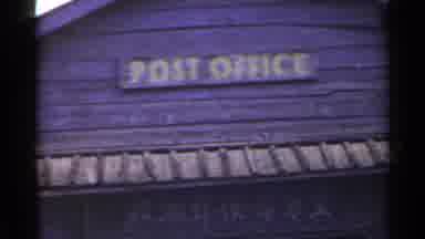 Japan (1953): Brown And Yellow Post Office Sign On A Cloudy Day