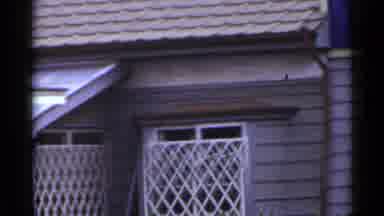 Japan (1953): Man Standing On The Roof Of A Small Shop Named Tailor Dressmaker