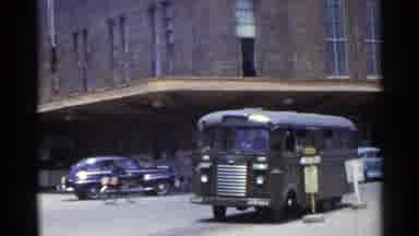 Japan (1953): The Camera Pans Away From A Bus Parked At A Bus Stop Onto The