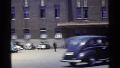 Japan (1953): Red And Blue Bus Parked In Parking Lot On A Bright Sunny Day