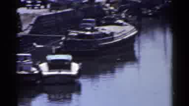 Japan (1953): A Bridge And Waterway With Boats Docked At The Harbor