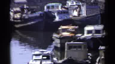 Japan (1953): Small Fishing Ships In The Marina While People And Vehicles Are