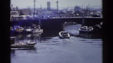 Japan (1953): Boat Heads Toward Bridge Then Cars Bicyclists And Buses Cross Over