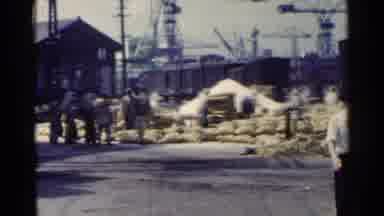 Japan (1953): Workers Removing Cargo Sacks From The Train With Ship Cranes On The