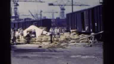 Japan (1953): Busy Workers Loading Freight Into Railroad Cars Near Blue Truck