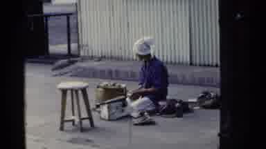 Japan (1953): Young Woman Sitting And Working With Basket And Men Tilling Field