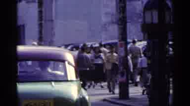 Japan (1953): Busy Street Scene Where Sidewalk Is Crowded Then Car Turns Then Man