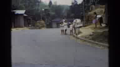 Japan (1953): Men Work In The Fields With Tools While Family Stands Beside A Road