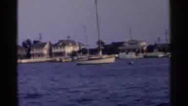 California (1955): Houses Line The Shore Of A Waterway Where Boats Are Tied At