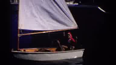 California (1955): Old Person Fishing From Small Sailboat On Lake
