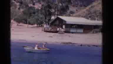 California (1955): Small Boat On A Blue Lake With People